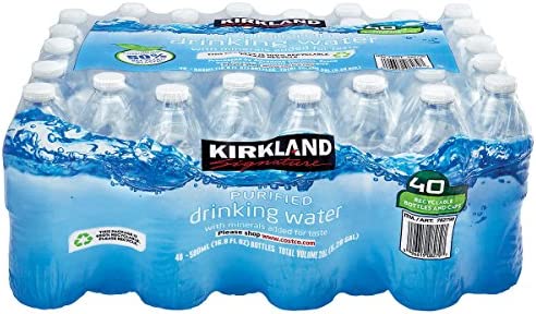 Kirkland brand 40-pack of bottled drinking water with clear plastic bottles arranged in shrink-wrapped packaging against blue water splash background.
