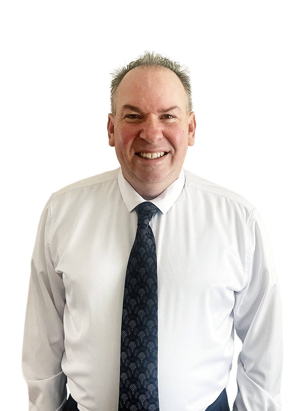 Smiling man in white dress shirt and dark patterned tie against white background, professional headshot style portrait.