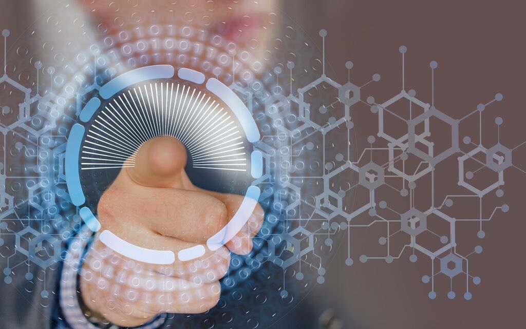 Hand holding glowing circular digital interface with molecular and binary code patterns on brown background.