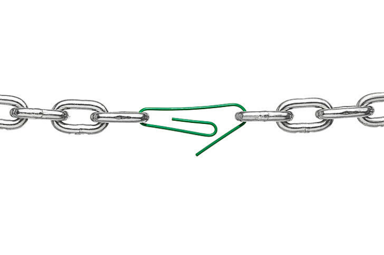 Green carabiner breaking through a chain of silver links against a white background.